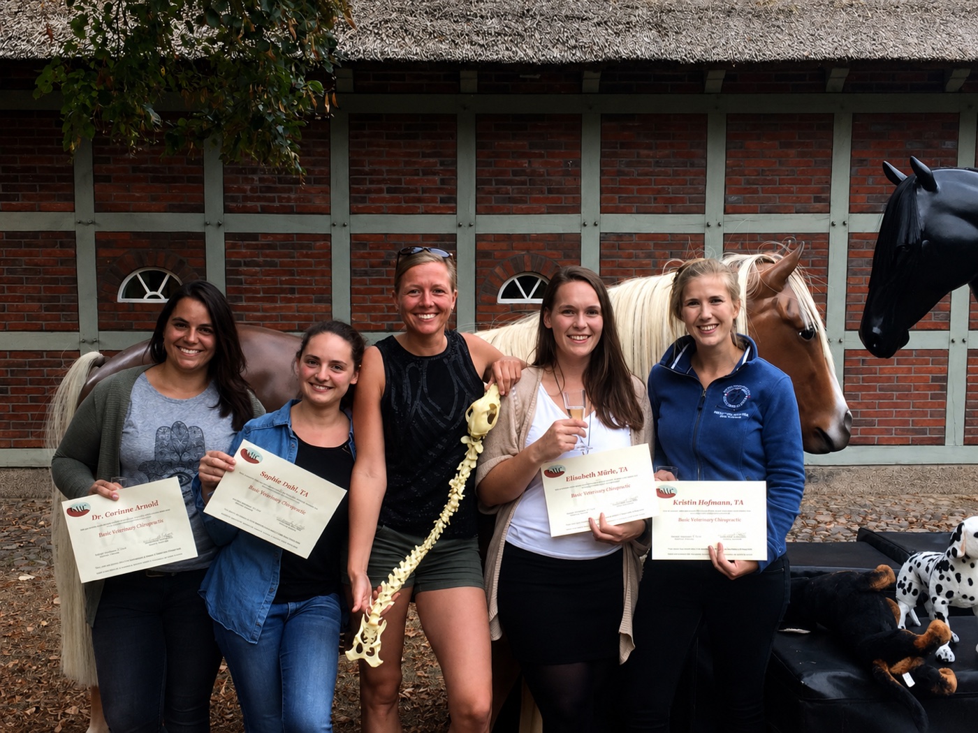 IAVC graduates holding their veterinary chiropractic certificates